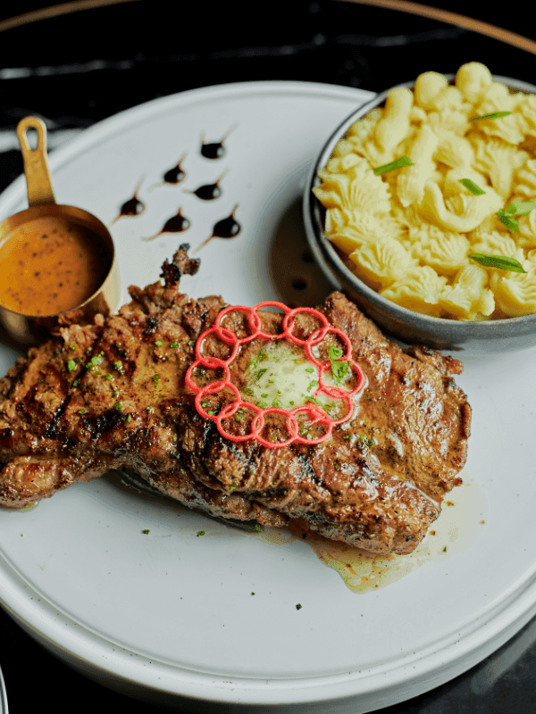 Seared steak with herb butter and mac and cheese