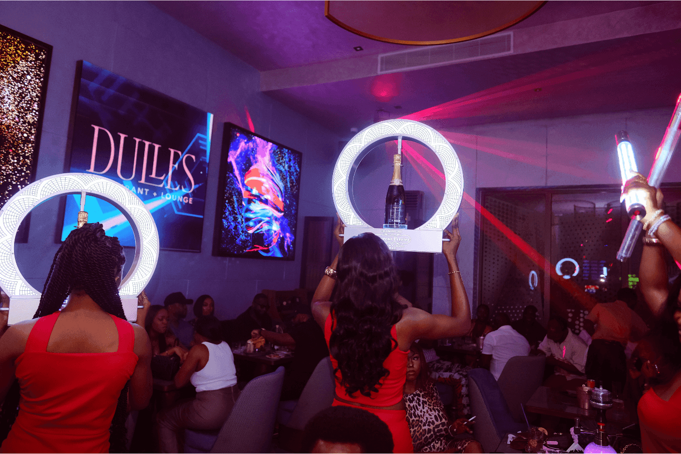 Guests in the Dulles lounge under neon light